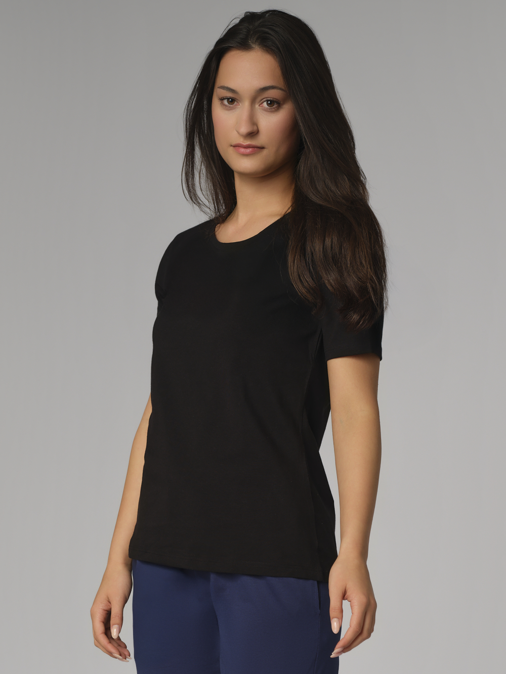 Front view: Woman wearing basic short-sleeve shirt by Comazo in the color Black with a crew neckline.
