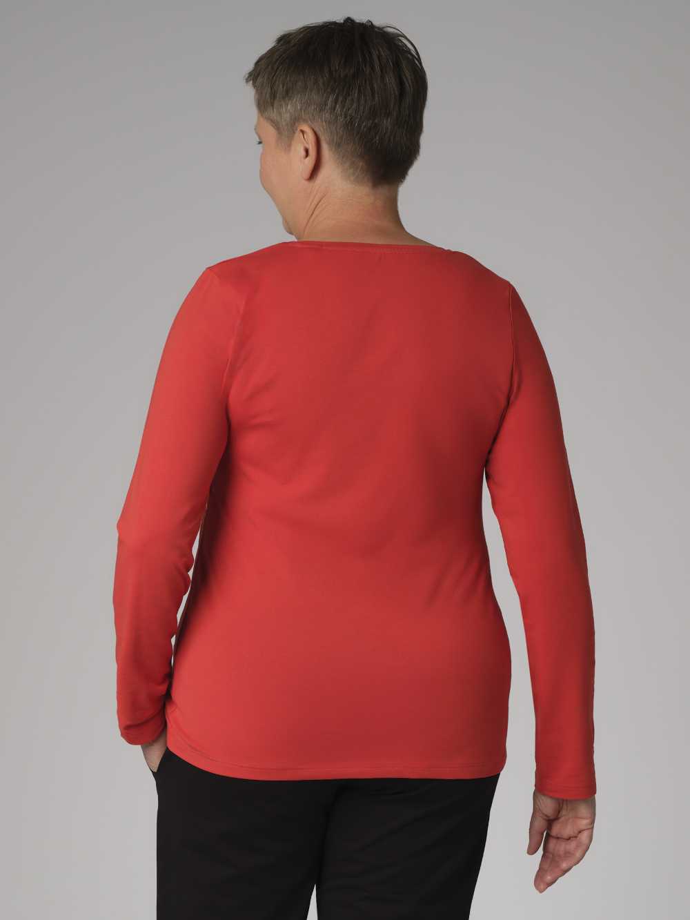 Rückansicht: Frau trägt Comazo Damen Basic Shirt langarm Farbe Paprika