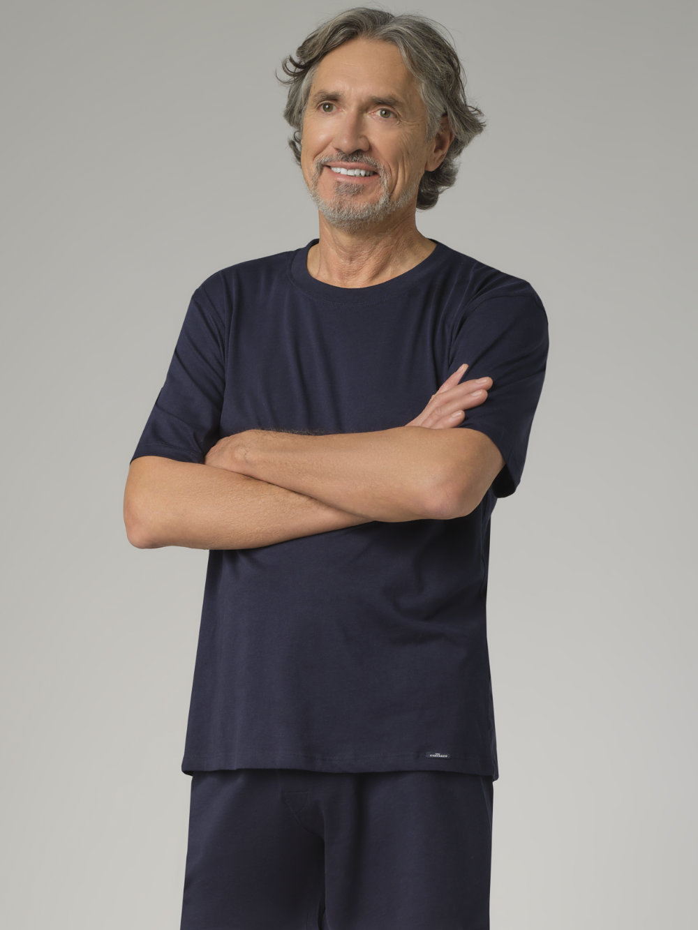 Front view: Man wearing Comazo American Style T-shirt in Marine color, made of 100% cotton, featuring a crew neck with ribbed collar.