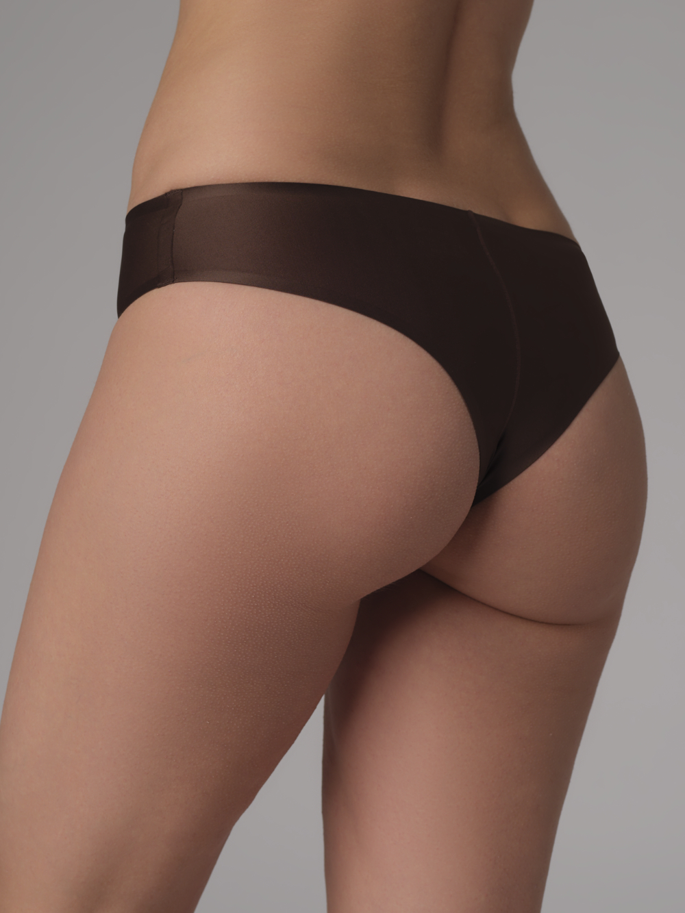 Back view: Woman wearing the bonded Brazil brief by Comazo in the color Mocca.