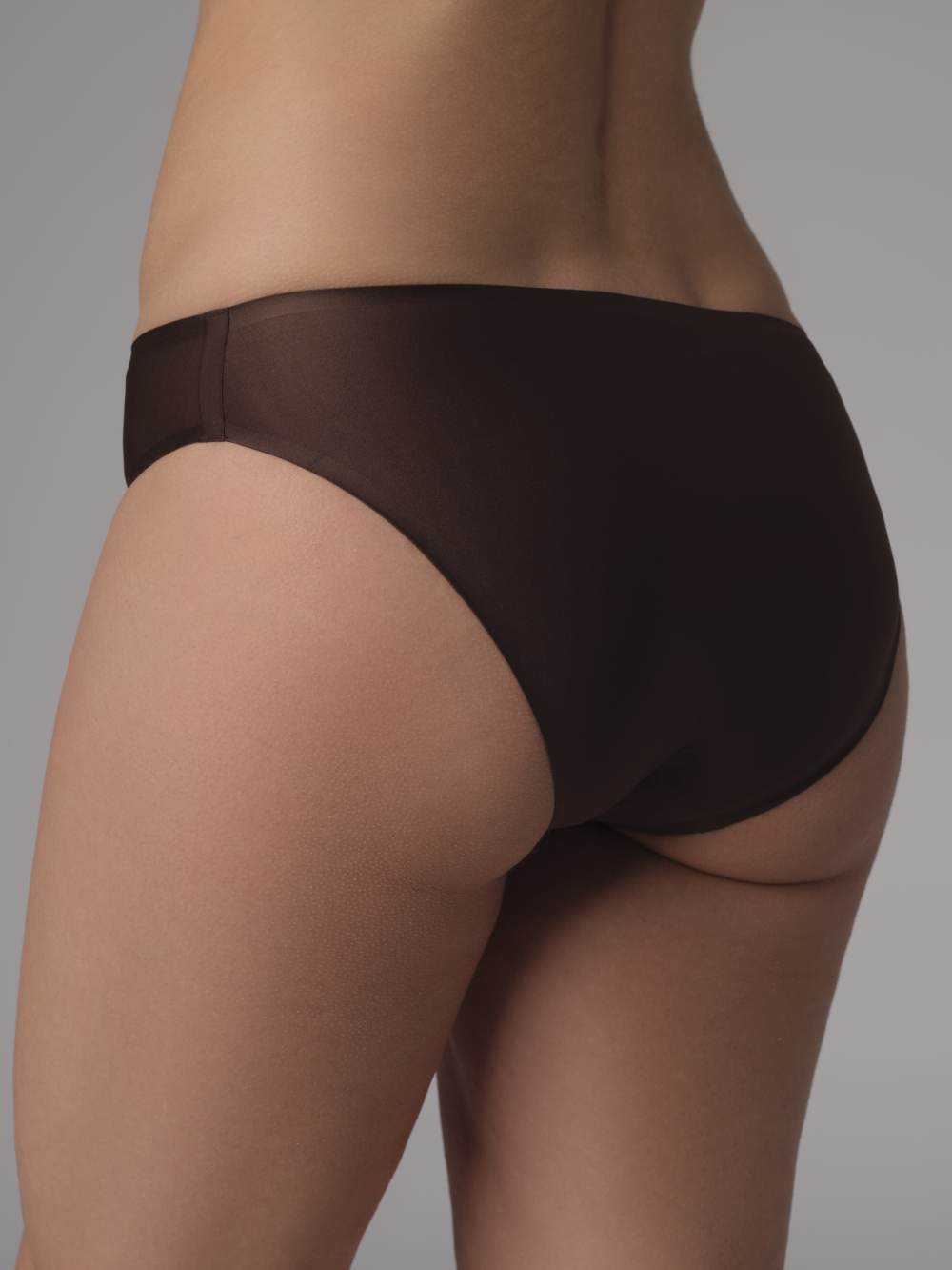Back view: Woman wearing Comazo Mini-Slip Bonded in Mocca