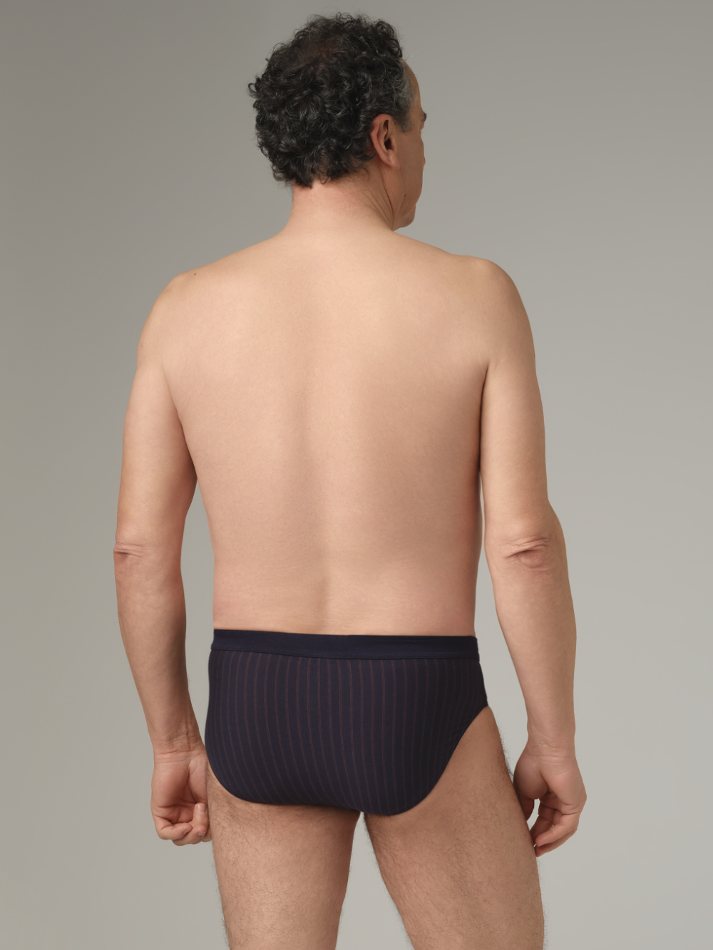 Front view: Man wearing Jazz pants by Comazo in navy/chocolate with stripes, made from 100% cotton.