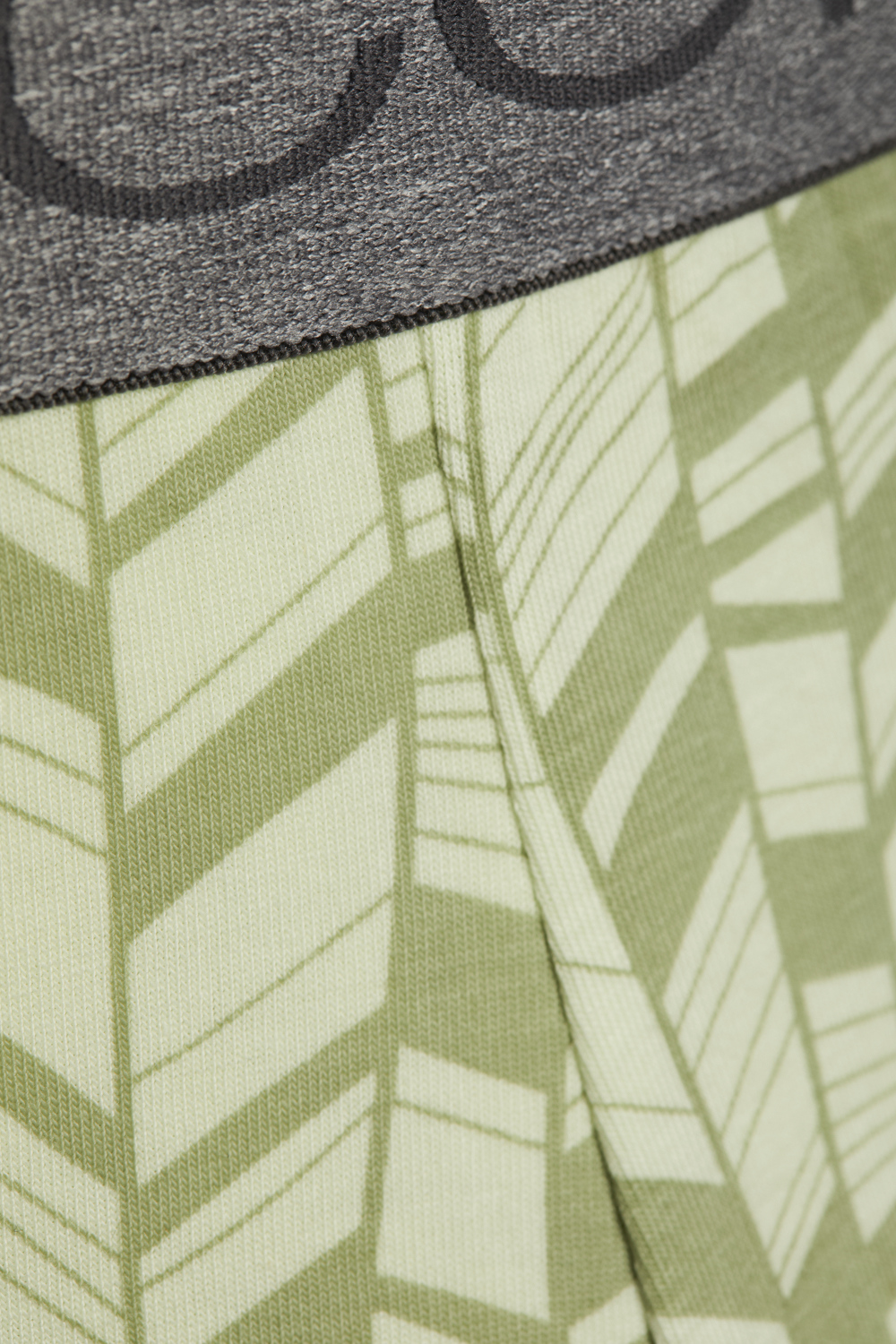 Detail view of Comazo men's trunks in printed lime cream