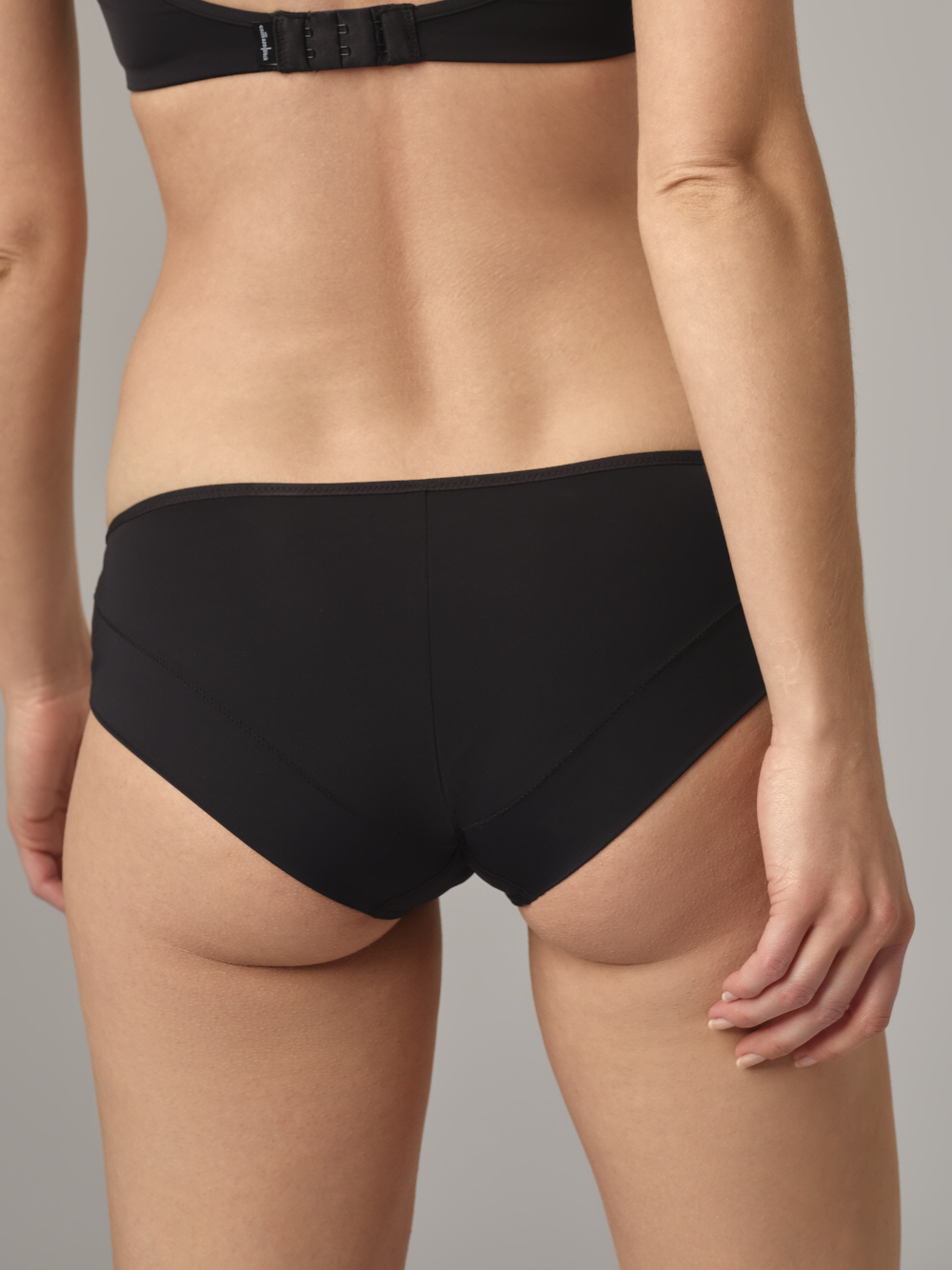 Rear view: Woman wearing Comazo Panty Color Black with Lace