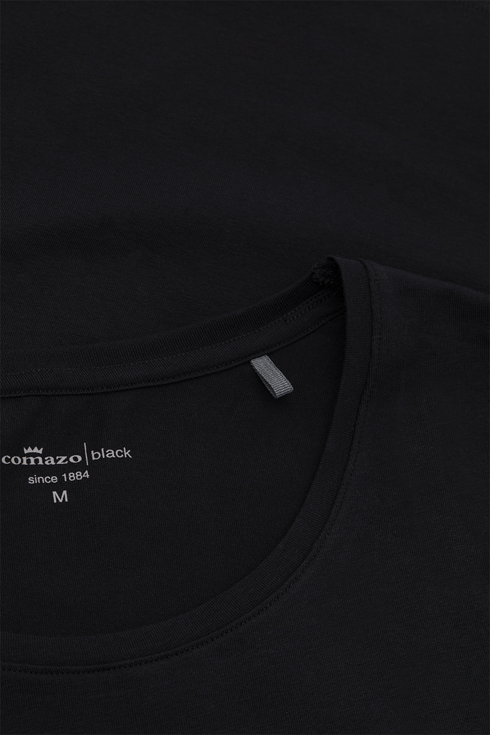 Detail image of basic short-sleeve shirt by Comazo in the color Black with a crew neckline.