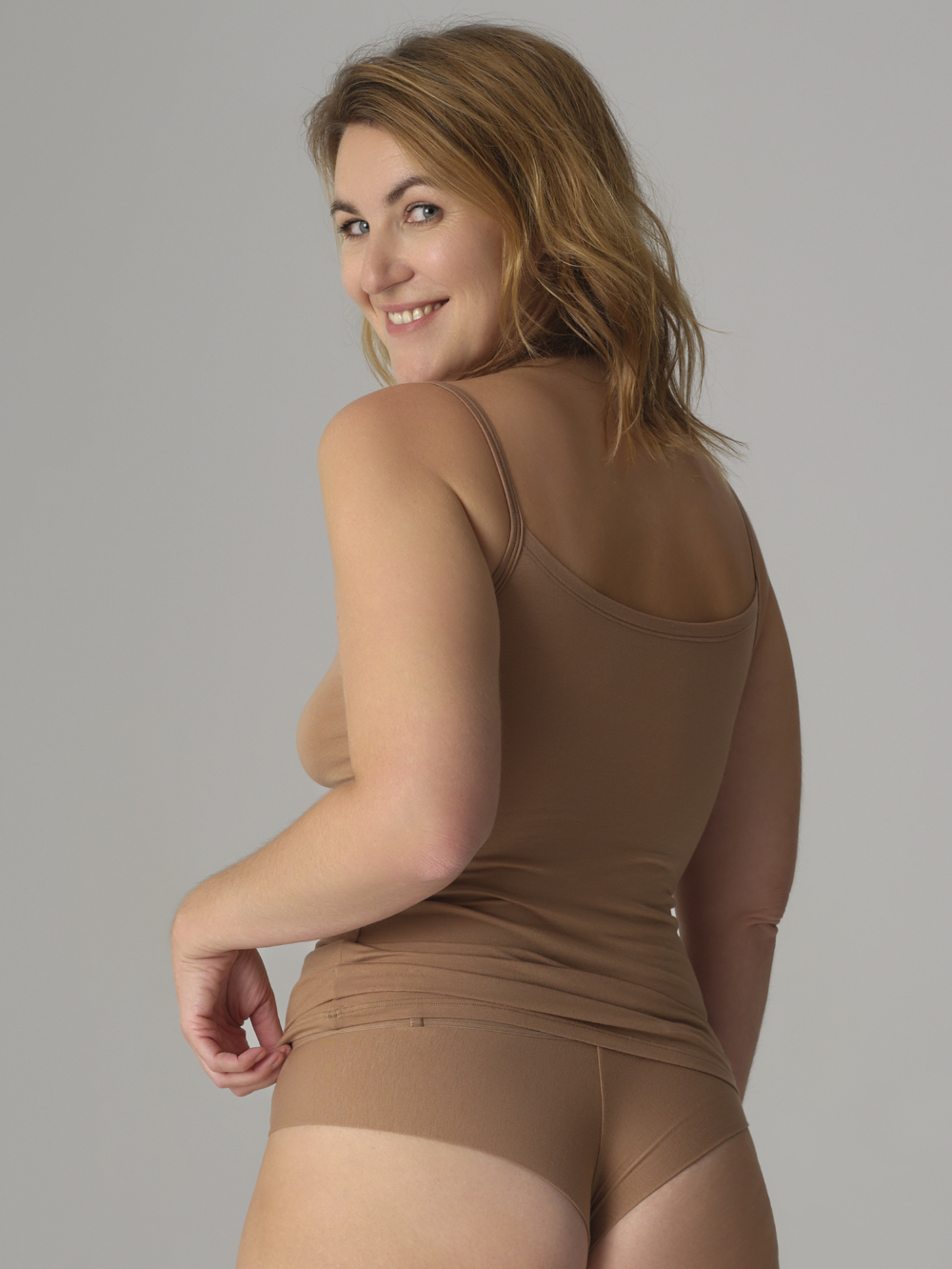 Rückansicht: Frau trägt Brasil-Slip von Comazo in der Farbe Biscotti aus MicroModal®