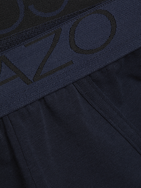 Detail view of short pants by Comazo in navy with logo waistband